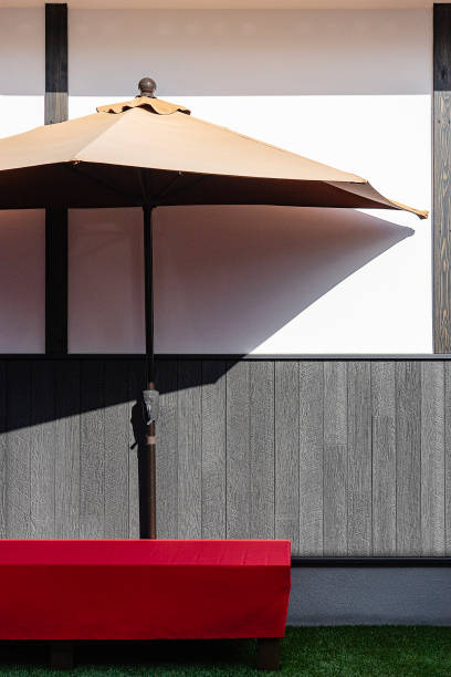 cafe on the beach surrounded by tropical greenery. summer cafe on the street. cafe outdoor furniture under sun umbrella. summer holiday concept. open beach umbrella in an outdoor bar on a sunny day