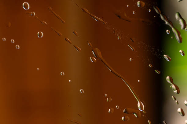 Rain drops during the rainy season on the window glass. Abstract background.