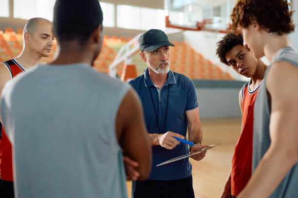 istock Basketball coach and his team going through game strategy before the match. 2151849698