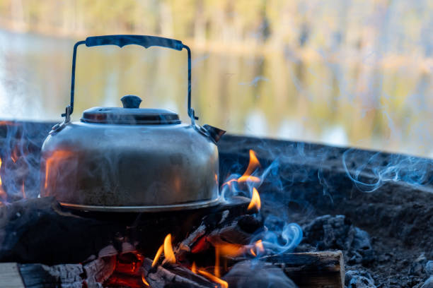 istock Camp kettle is heated on a bonfire. Hiking concept. 2151849858