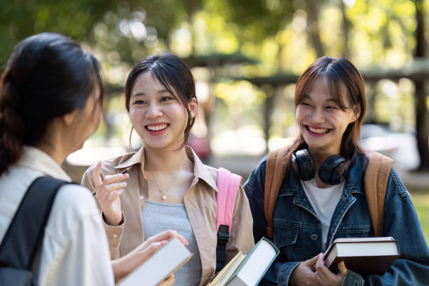 istock Happy students walking together on university campus, chatting and laughing outdoors after classes 2151851168