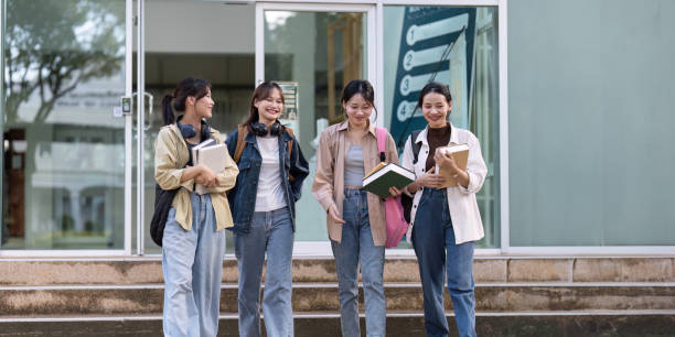 istock Female student walking to class with friends and chatting about the class 2151851249