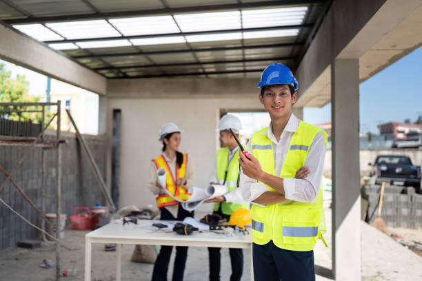 istock electrical engineer stand with walkie-talkie in construction building and engineer colleagues are working in the background 2151851266