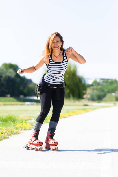 istock roller skating girl on asphalt road outdoors on a hot summer day 2151852390