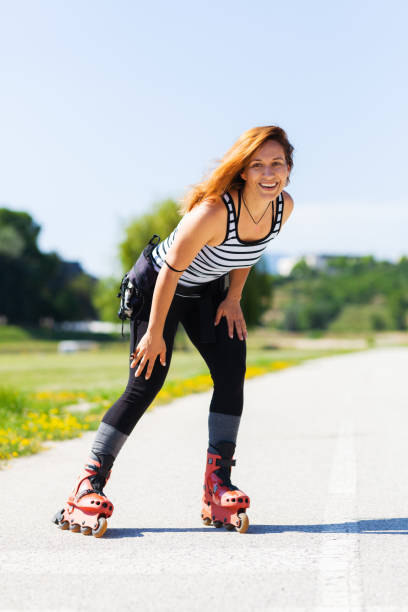 istock roller skating girl on asphalt road outdoors on a hot summer day 2151852403