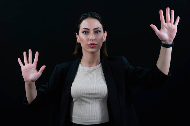 istock Woman using the virtual reality headset. Nice young woman using transparent screen, Technology concept. Black background. 2151855474