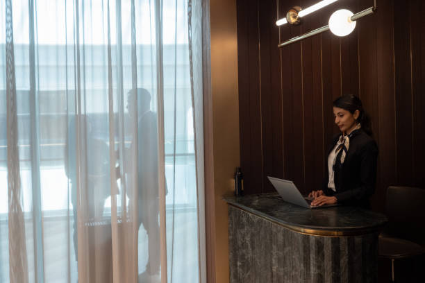 istock Airport lounge receptionist / hotel concierge busy at work 2151855697