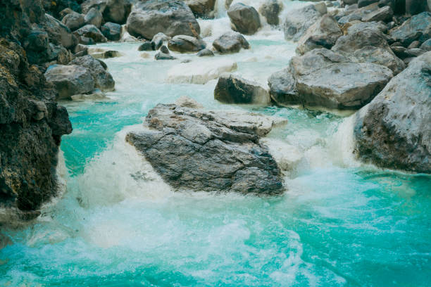 A small mountain stream flows through the stones on the slope