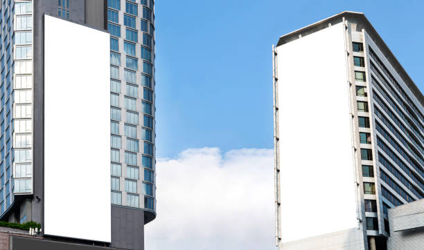 istock Two outdoor vertical billboard on building  with blue sky background 2151858313