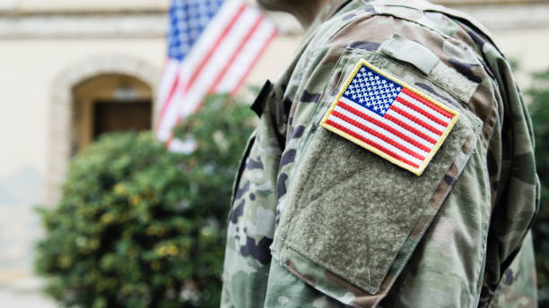 istock General Instills Valor In American Serviceman With Flag For His Service 2151859368