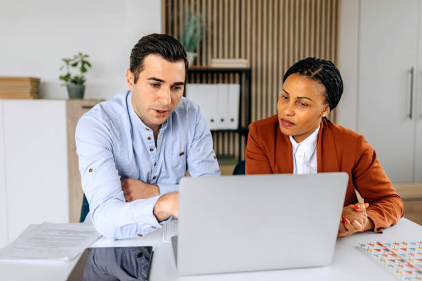 istock Colleagues discussing work at the office together 2151859744