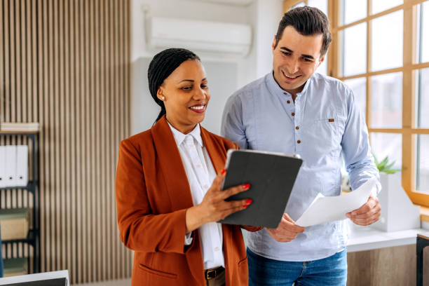 istock Colleagues discussing work while walking together at the office 2151860033