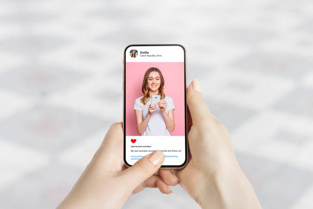 istock Woman looking at beautiful model's photo. Social network post concept 2151860120