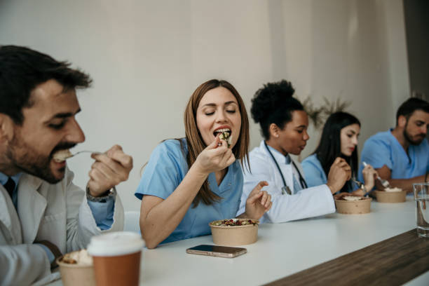 istock Diverse doctors and nurses having a lunch together 2151860759