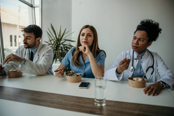 istock Tired medical workers eating 2151860899