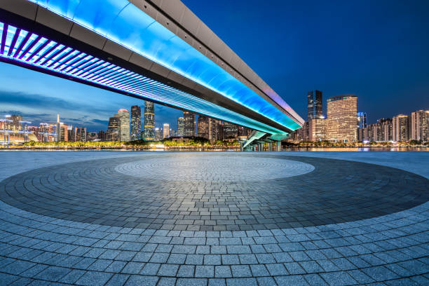 istock Empty square floor and pedestrian bridge with modern city buildings at night 2151862310