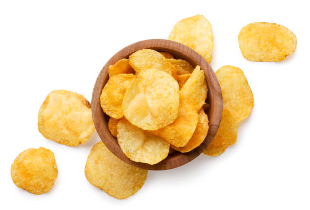 istock Potato chips in a wooden plate and scattered on a white background. Top view 2151863039