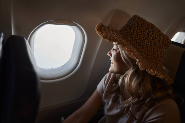 istock Happy woman enjoying while traveling by plane. 2151864264