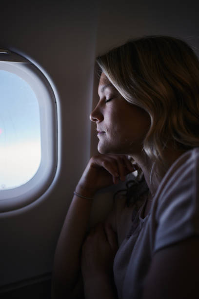 istock Relaxed woman taking a nap in a plane. 2151864680