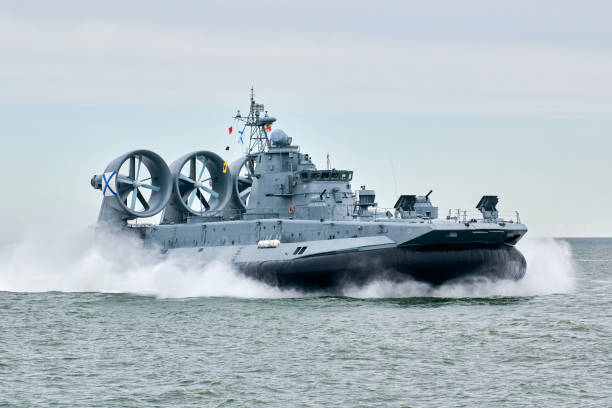 istock Hovercraft warship armed with armament sails into sea toward military target to attack and destroy 2151866765