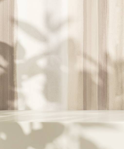 istock Minimal empty white stone countertop in sunlight, tropical leaf foliage shadow on beige brown wall 2151866812