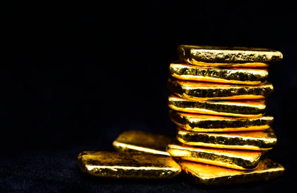 Close up photo a gold bars on black background, copy space