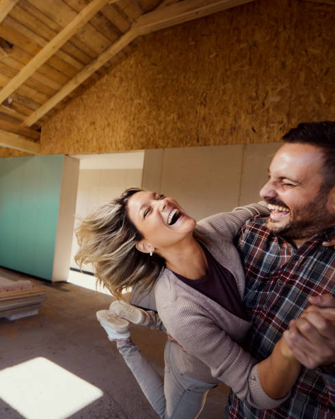 istock Cheerful couple having fun inside of their developing house. 2151868014