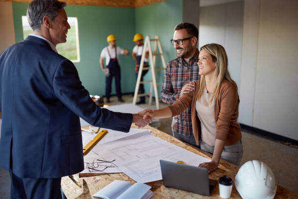 istock Happy couple came to an agreement with architect at construction site. 2151868174