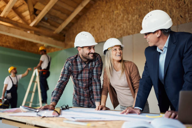 istock Happy couple talking about plans with an architect at construction site. 2151868259
