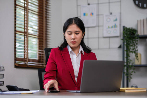istock Young businesswoman has problems with her work in the office Feeling stressed and unhappy, showing a serious expression 2151869618