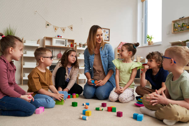 istock Teacher performs exercises to the children 2151871294