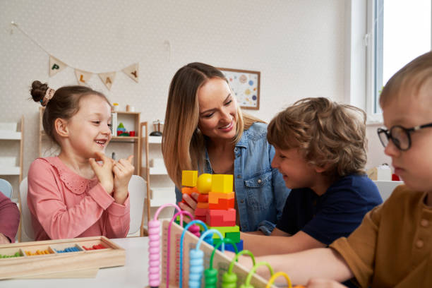 istock Teacher and children doing sensory exercises in the kindergarten 2151871336