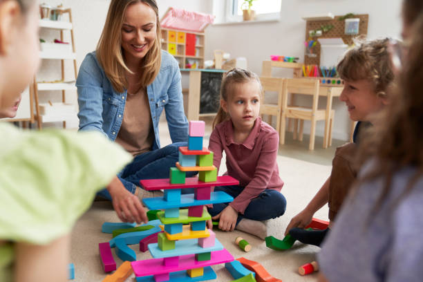 istock Children playing with toy blocks in the kindergarten 2151871874