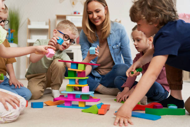 istock Children playing with toy blocks in the kindergarten 2151871912