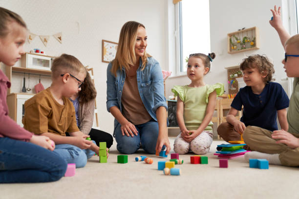 istock Teacher performs exercises to the children 2151871933