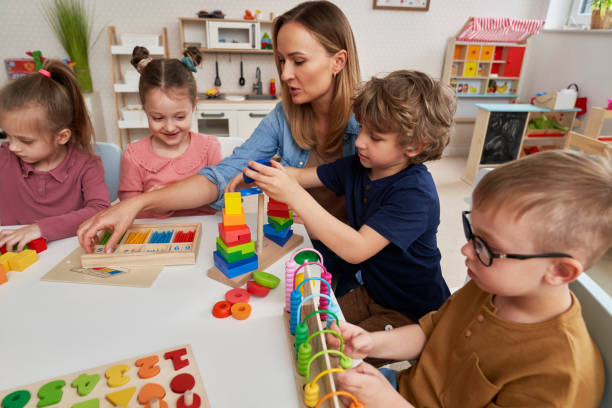 istock Teacher and children doing sensory exercises in the kindergarten 2151871999