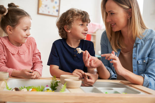 istock Physiotherapist performs exercises to the children 2151872008
