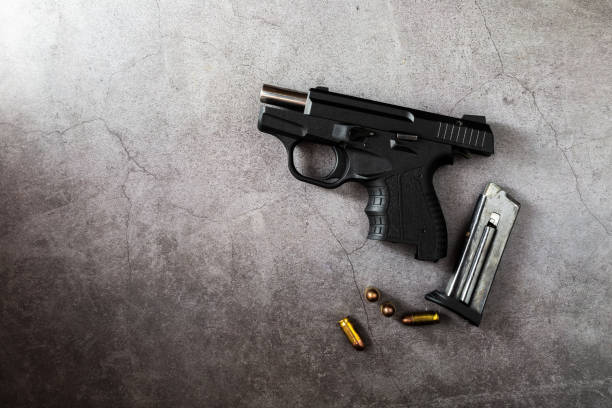 istock 9 mm gun with bullets on the table 2151872255