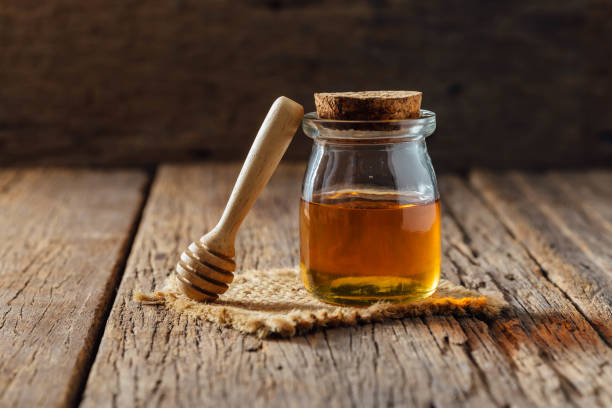 istock honey on wooden background 2151872351