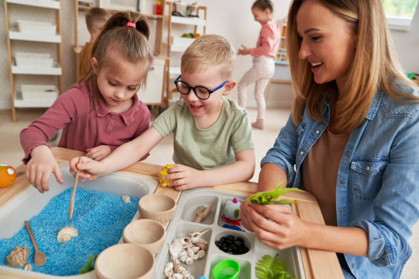 istock Physiotherapist performs exercises to the children 2151872448