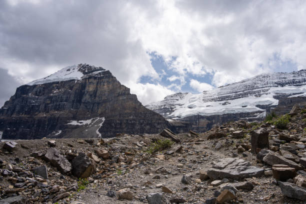 Closeup of a snowcapped mountain peak under cloudy sky, viewed from Sulphur Mountain Boardwalk at Banff National Park