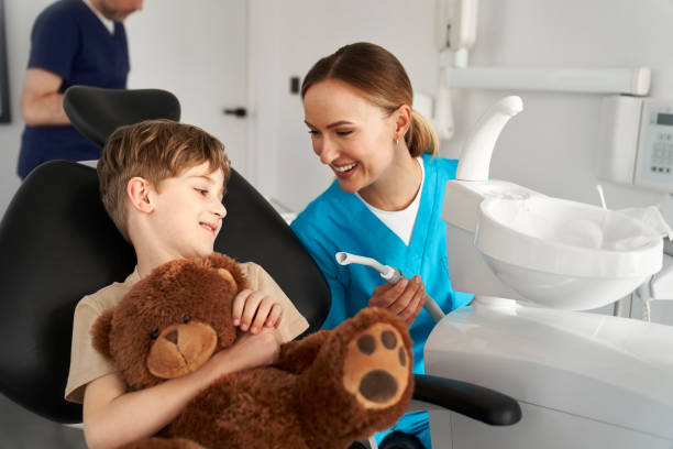 istock Child holding a teddy bear at the dentist's office 2151876205