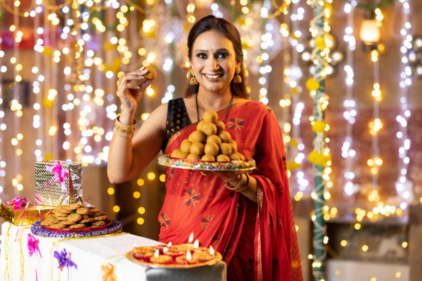 istock Young woman diwali celebrate with sweets 2151876753