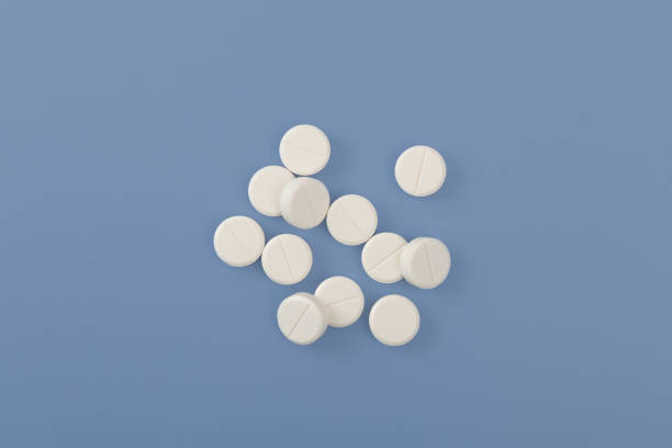 istock White pills or tablets on blue background. Concept Placebo effect in medicine. Tendency increased consumption of medications, antidepressants and sedative pills 2151878914