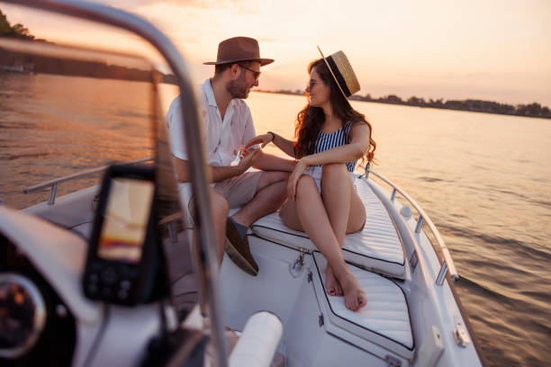 istock Couple sailing to the sunset on a boat while on summer vacation 2151879850