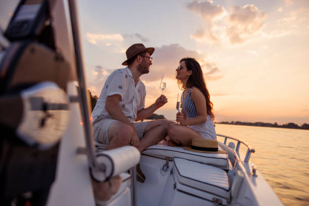 istock Couple having fun drinking champagne and sailing on a boat while on summer vacation 2151879971