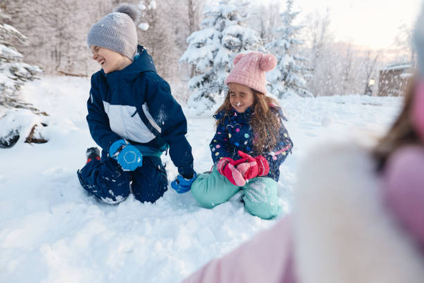 istock Happy kids enjoying winter snow 2151880299