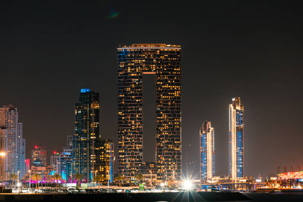 Dubai, United Arab Emirates - March 3, 2024: Night view of the Address Beach Resort Tower illuminated, dominating the Dubai Marina skyline