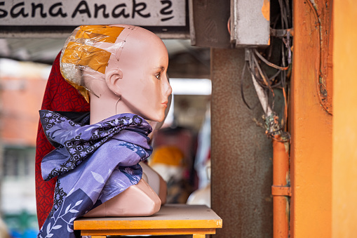 Bukittinggi, West Sumatra, Indonesia - February 4th 2024:  Display mannequin prepared for showing a hijab with the characteristic hair collection on the back of the head at a street market