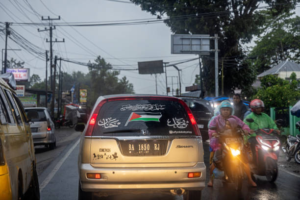 Kecamatan tilatang Kamang, West Sumatra, Indonesia - February 3rd 2024:  Car with a Palestinian flag in the rear window in traffic in the very late afternoon